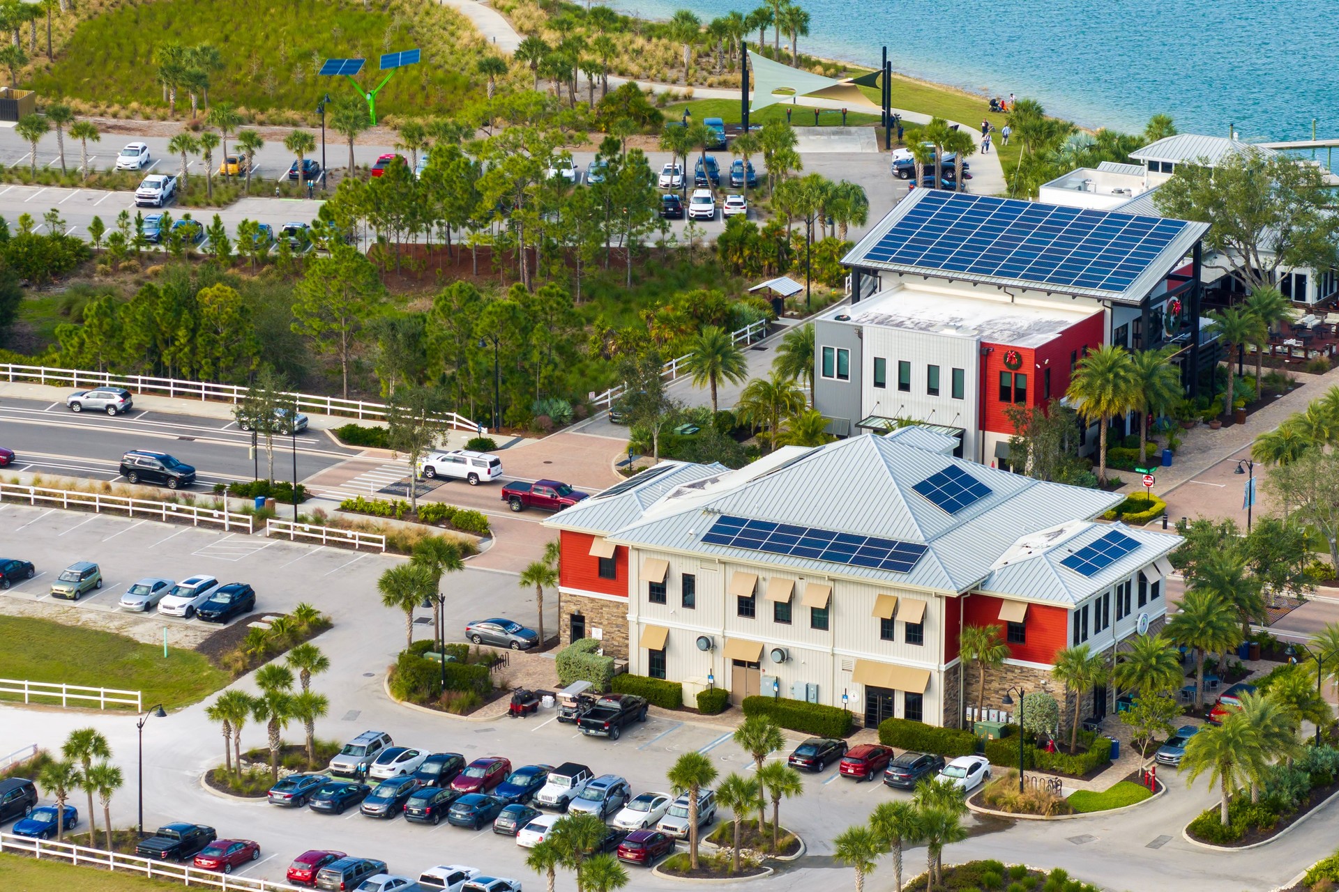 Florida office buildings with solar roof in small autonomous town. Blue photovoltaic panels for producing clean ecological electric energy. Investing in renewable electricity concept