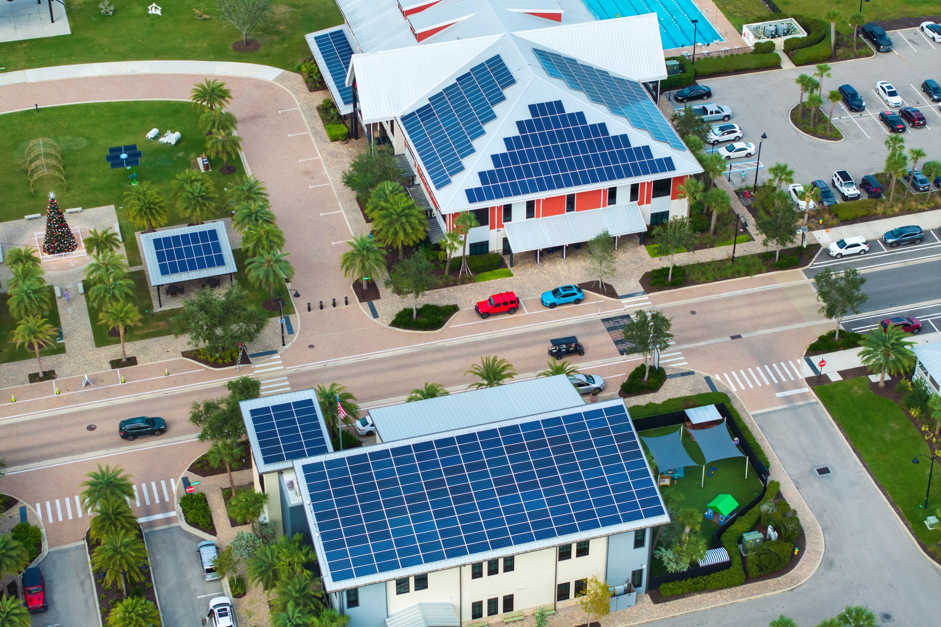Florida office building with solar roof. Blue photovoltaic panels for producing clean ecological electric energy. Investing in renewable electricity concept